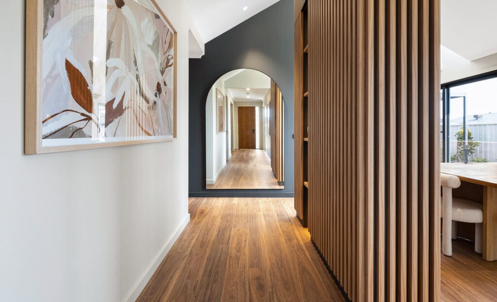 Home hallway with wood floor, slatted wood panelling and mirror