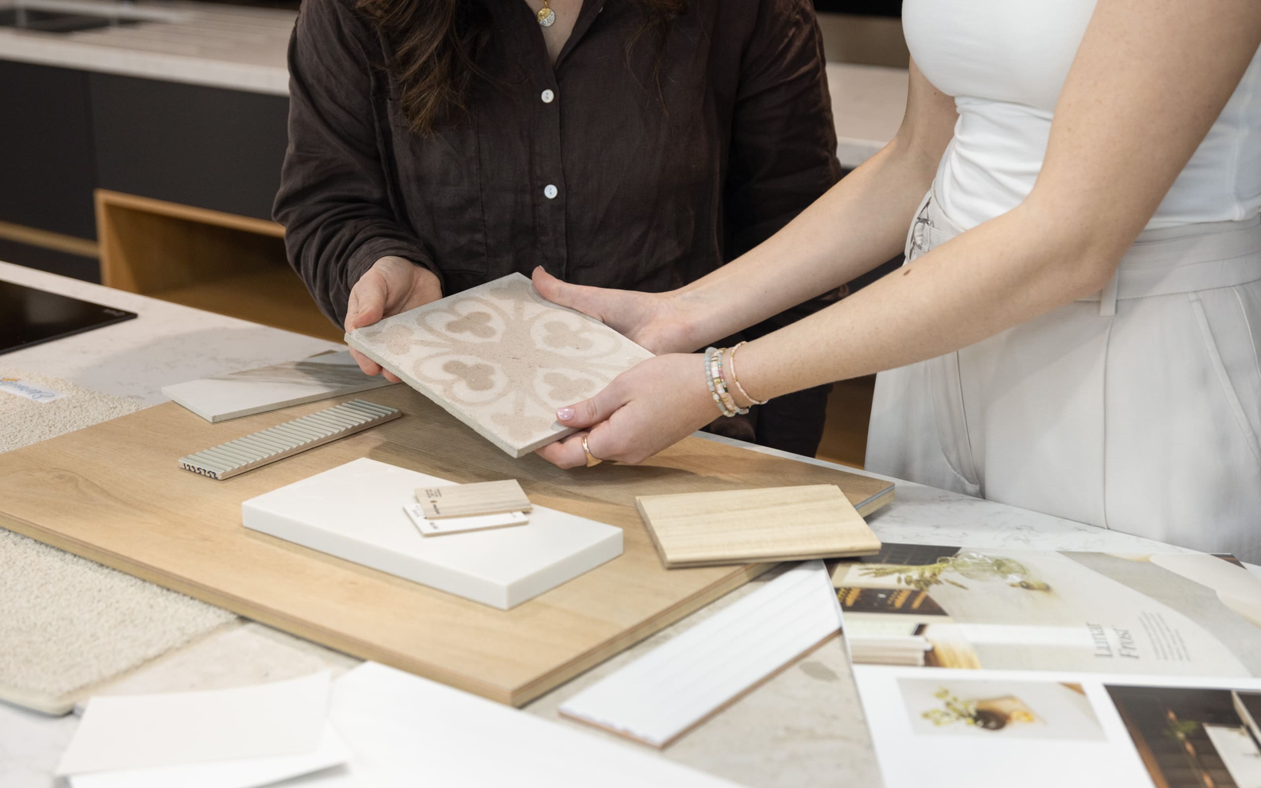 Designers reviewing a decorative tile sample together
